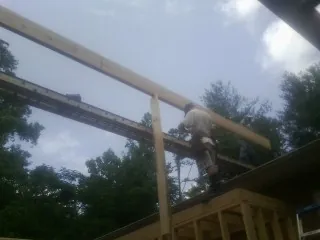 Carpenter setting a ridge beam over a new addition frame — Ice Dam Removal by Roofing Brothers in Gardnerville